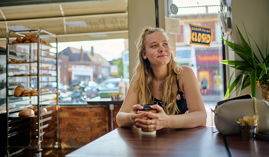 Scarlett sitting in a coffee shop