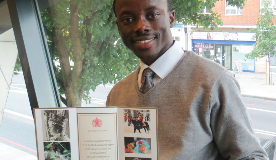 Anthony Boateng with his letter from Her Majesty's letter