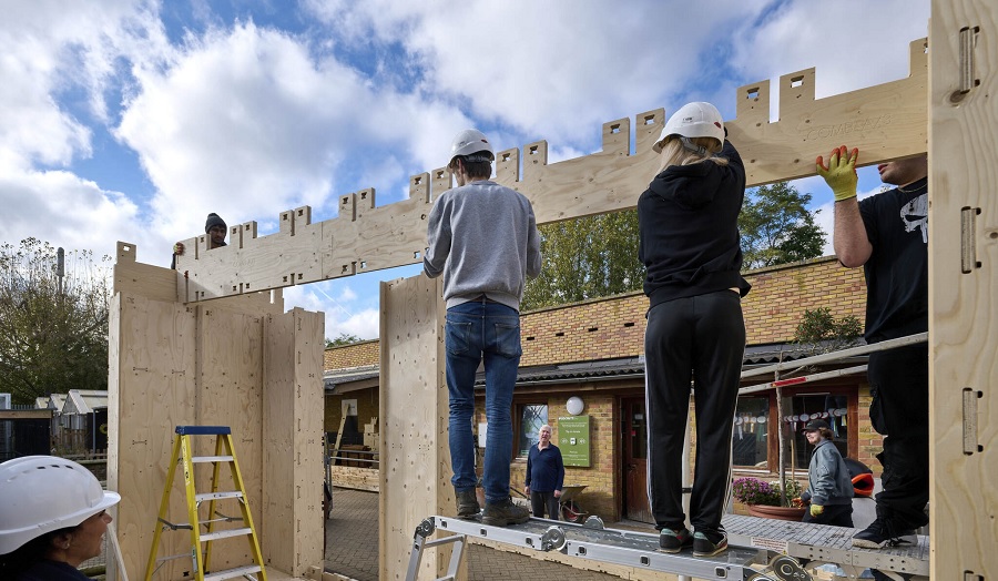 students putting together a timber building structure