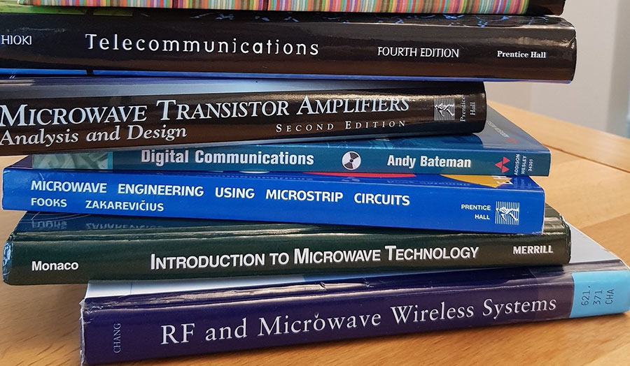 stack of books relating to communications technology