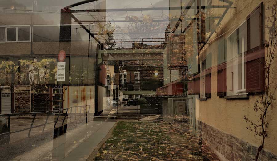 street scene featuring a building alongside a fence, showcasing urban architecture and outdoor space