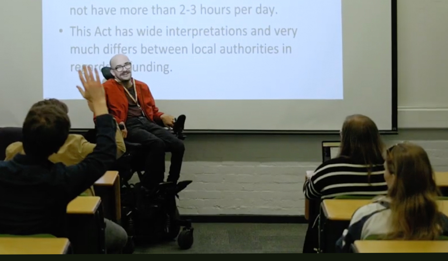 Josh Hepple pictured in London Met classroom with whiteboard in background and students in front