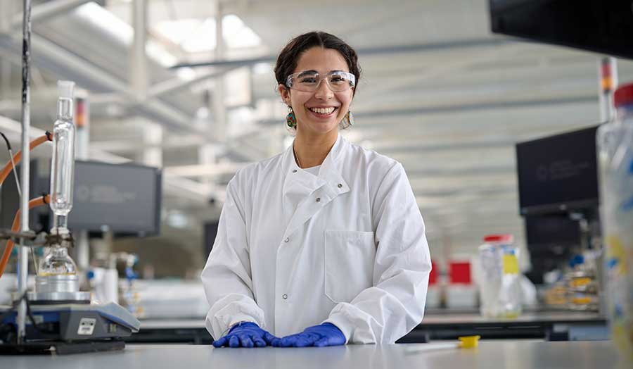 Carola pictured in London Met's superlab smiling in labcoat 