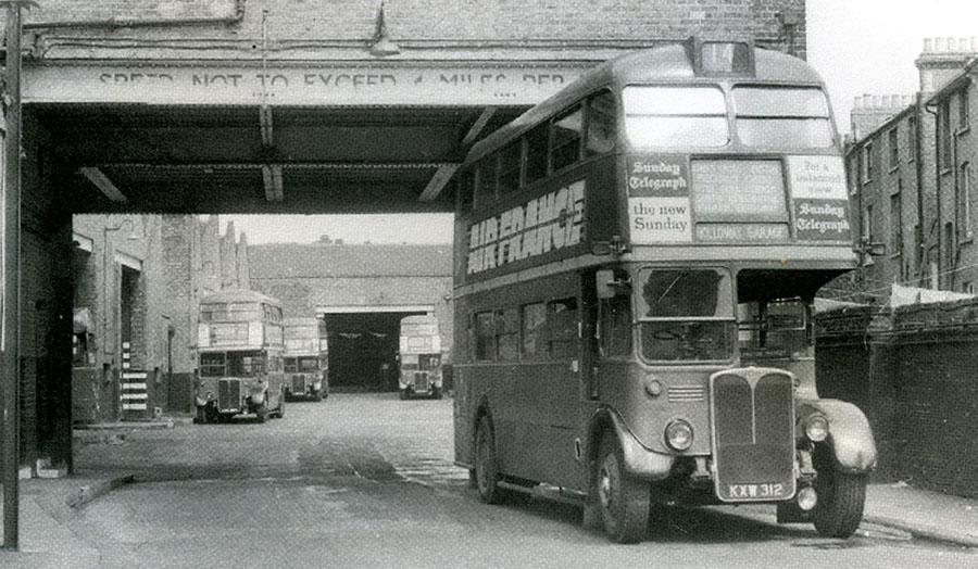 A black and white photo of a double decker bus on Holloway Road