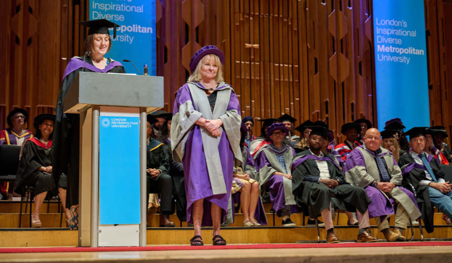 Lynn Dobbs receiving Dean's speech at graduation