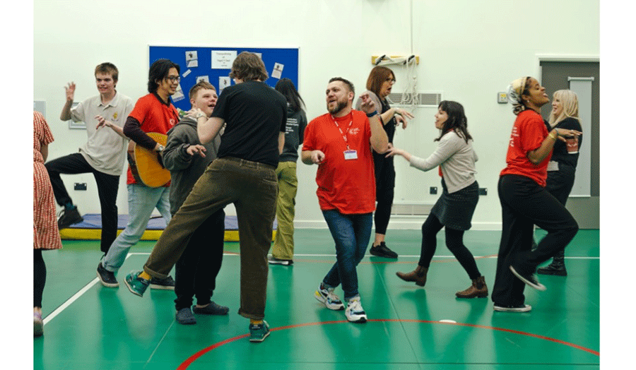 A group of young people: able-bodied and disabled at theatre rehearsal