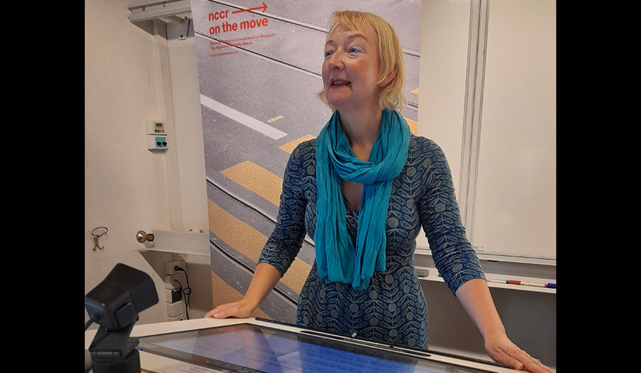 Louise Ryan stands at a lectern.