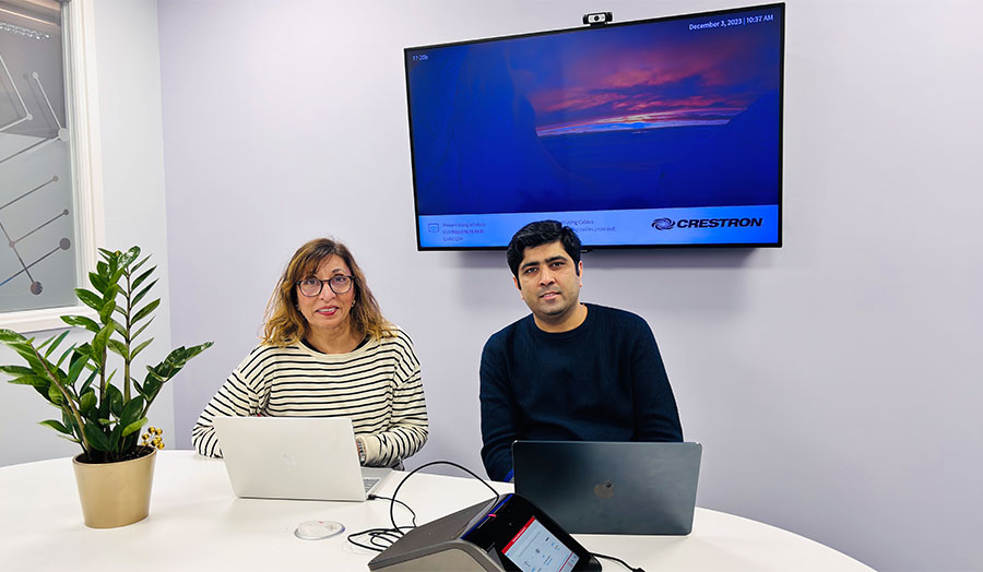 The project team sit at a table smiling