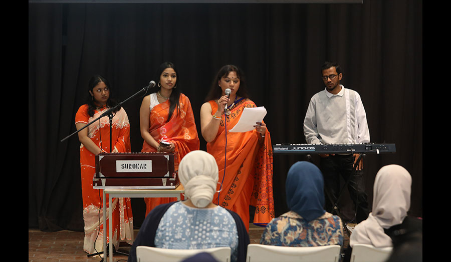 Four musicians perform in front of an audience